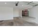 Spacious three car garage with tall ceilings, metal shelving and automatic door opener at 18988 W Cortez St, Surprise, AZ 85388