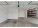 Spacious three car garage with tall ceilings, metal shelving and automatic door opener at 18988 W Cortez St, Surprise, AZ 85388