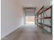 Spacious three car garage with tall ceilings, metal shelving and automatic door opener at 18988 W Cortez St, Surprise, AZ 85388