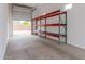 Spacious three car garage with tall ceilings, metal shelving and automatic door opener at 18988 W Cortez St, Surprise, AZ 85388