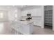 Bright white kitchen featuring a large island with granite countertops and stainless steel appliances at 18988 W Cortez St, Surprise, AZ 85388