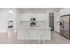 Open kitchen featuring white cabinets, granite countertops, stainless steel appliances, and an island with seating at 18988 W Cortez St, Surprise, AZ 85388