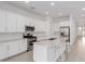 Open kitchen with white cabinets, stainless steel appliances, granite countertops and island with bar seating at 18988 W Cortez St, Surprise, AZ 85388
