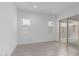 Light-filled living room features tile flooring, windows and sliding glass doors to the backyard at 18988 W Cortez St, Surprise, AZ 85388