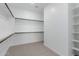 Spacious walk-in closet with built-in shelving and hanging rods for organization at 18988 W Cortez St, Surprise, AZ 85388