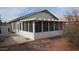 Enclosed sunroom enhancing outdoor living, surrounded by landscaped yard and easy access to the backyard at 20479 N 105Th Ave, Peoria, AZ 85382
