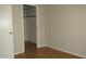 Neutral bedroom features a spacious closet and wood-look flooring, offering a cozy, adaptable space at 20479 N 105Th Ave, Peoria, AZ 85382