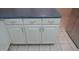 White kitchen cabinets with modern hardware and countertops at 20479 N 105Th Ave, Peoria, AZ 85382