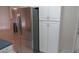 Modern kitchen with stainless steel refrigerator and ample white cabinet storage at 20479 N 105Th Ave, Peoria, AZ 85382