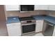 Kitchen showcasing stainless steel oven, cooktop, and microwave over white cabinets at 20479 N 105Th Ave, Peoria, AZ 85382