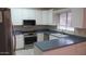Bright kitchen with white cabinets, stainless steel appliances, and blue countertops at 20479 N 105Th Ave, Peoria, AZ 85382