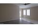 Open-concept living room with plank flooring, tile floors and slider door at 20479 N 105Th Ave, Peoria, AZ 85382