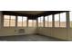 Bright sunroom with multiple windows providing natural light and views, featuring an air conditioner unit at 20479 N 105Th Ave, Peoria, AZ 85382