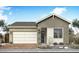 Charming single-story home showcasing a two-car garage, stone accents, and neutral color palette at 2152 E Mill Rd, San Tan Valley, AZ 85140