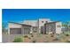 Contemporary-style home featuring a desert landscape, gray brick accents and a two-car garage at 21975 S 193Rd Way, Queen Creek, AZ 85142