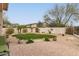 Lush backyard featuring desert landscaping, manicured lawn and brick paver patio at 2212 W Calle De Las Estrella St, Phoenix, AZ 85085