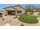 Lush backyard featuring a manicured lawn, desert landscaping and a covered patio at 2212 W Calle De Las Estrella St, Phoenix, AZ 85085