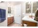 Bright bathroom featuring double sink vanities, mirrors and neutral tile floors at 2212 W Calle De Las Estrella St, Phoenix, AZ 85085