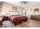 Well-lit bedroom with wood-look floors and features a large bed, dresser, and ensuite bathroom at 2212 W Calle De Las Estrella St, Phoenix, AZ 85085
