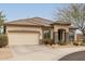 Single-story home showcasing desert landscaping, neutral color palette, and a two-car garage at 2212 W Calle De Las Estrella St, Phoenix, AZ 85085