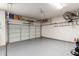 Spacious two car garage featuring clean epoxy floors, shelving, and ample storage at 2212 W Calle De Las Estrella St, Phoenix, AZ 85085