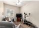 Home office equipped with a desk, exercise equipment, wood floor, and a large window with blinds at 2212 W Calle De Las Estrella St, Phoenix, AZ 85085