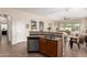 Contemporary kitchen boasts an island with a sink and dishwasher, and an open view to the living space at 2212 W Calle De Las Estrella St, Phoenix, AZ 85085