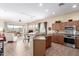 Open-concept kitchen features stainless steel appliances, a breakfast bar, and seamless flow to the living area at 2212 W Calle De Las Estrella St, Phoenix, AZ 85085