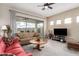 Bright living room with sliding glass doors, neutral-toned furniture, and views of the outdoors at 2212 W Calle De Las Estrella St, Phoenix, AZ 85085