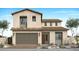 Beige two-story home showcasing a welcoming front door, brown tile roofing, and a spacious two-car garage at 2242 E Foremaster Rd, San Tan Valley, AZ 85140