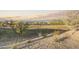 Scenic community view with lush greenery, trees, and homes in the background under a vibrant sky at 23984 W Cocopah St, Buckeye, AZ 85326