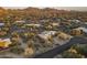 Desert community featuring an expansive property with views, lush desert vegetation, and a paved road at 25031 N Paso Trl, Scottsdale, AZ 85255