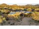 Aerial view of desert home featuring solar panels and landscaped grounds in a serene setting at 25031 N Paso Trl, Scottsdale, AZ 85255