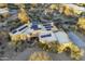 Overhead view highlights solar panels, desert landscaping, pool, driveway and the surrounding desert at 25031 N Paso Trl, Scottsdale, AZ 85255