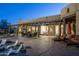 Resort-style backyard with covered patio, in-pool seating, lounge chairs, and desert landscaping at 25031 N Paso Trl, Scottsdale, AZ 85255