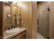 Neutral bathroom featuring a single sink vanity and a glass enclosed walk in shower at 25031 N Paso Trl, Scottsdale, AZ 85255