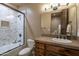 Bathroom featuring tile shower and stone countertop at 25031 N Paso Trl, Scottsdale, AZ 85255