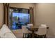 Cozy dining area with mountain views, a square table, and upholstered chairs near a picture window at 25031 N Paso Trl, Scottsdale, AZ 85255