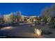 Stunning exterior of desert home with a stone address marker and desert landscaping at twilight at 25031 N Paso Trl, Scottsdale, AZ 85255