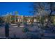 Beautiful southwestern home exterior showcasing native desert landscaping and architectural charm at 25031 N Paso Trl, Scottsdale, AZ 85255