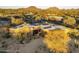 Stunning desert home boasts solar panels and lush native landscaping, creating an inviting and sustainable facade at 25031 N Paso Trl, Scottsdale, AZ 85255