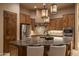Gourmet kitchen with custom cabinets, stainless steel appliances, and a large center island with seating at 25031 N Paso Trl, Scottsdale, AZ 85255