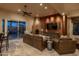 Inviting living room features a cozy fireplace, leather furniture, and sliding glass doors to the patio at 25031 N Paso Trl, Scottsdale, AZ 85255