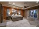 Spacious main bedroom boasts a tray ceiling, a sliding barn door, and a luxurious ensuite bathroom at 25031 N Paso Trl, Scottsdale, AZ 85255
