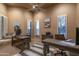 Home office with multiple desks, plantation shutters, and neutral colors at 25031 N Paso Trl, Scottsdale, AZ 85255