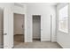 Cozy bedroom featuring closet, plush carpet, and natural light at 25443 W Graham Trl, Buckeye, AZ 85326
