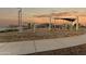 Community playground with climbing structures, sun shades, and sidewalks in a modern planned community at 25443 W Graham Trl, Buckeye, AZ 85326