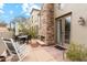 Back patio featuring a fireplace, outdoor seating, and charming landscaping creates a relaxed outdoor living space at 28990 N White Feather E Ln # 182, Scottsdale, AZ 85262