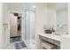 Bathroom with a glass shower, vanity area and walk-in closet with custom shelving at 28990 N White Feather E Ln # 182, Scottsdale, AZ 85262