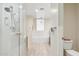 Bright bathroom featuring a walk-in shower, soaking tub, and neutral tile flooring at 28990 N White Feather E Ln # 182, Scottsdale, AZ 85262